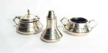 A George V silver three-piece cruet set of Art Deco design, comprising mustard pot,