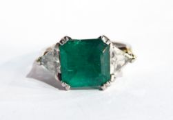 A platinum, emerald and diamond ring set central emerald (5.