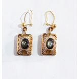 A pair of gold-coloured metal pendant drop earrings in pierced rectangular setting,