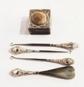 Three silver-handled button hooks,