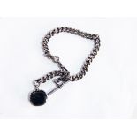 A silver albert chain, curb link with swivel seal fob,