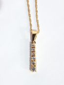 A gold pendant set with six graduated brilliant cut diamonds, in claw settings,