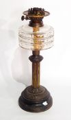A Victorian brass and glass oil lamp having cut glass well, on fluted column,