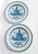 A pair of Delft blue and white plates, each with Chinese style lakeside landscape decoration,