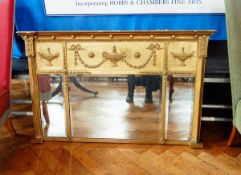 A rectangular gilt Regency style mirror with urn and swag decoration, with "Jones & Higgins,