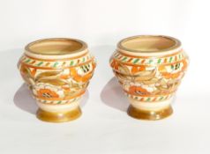 A pair of Crown Ducal Charlotte Rhead vases of ribbed form with tube lined floral decoration,