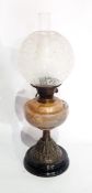 A Victorian mottled glass and brass oil lamp with chimney and etched shade and another chimney