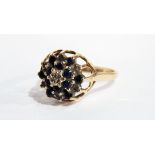 A 9ct gold, sapphire and diamond dress ring with small central diamond surrounded by sapphires,