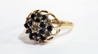 A 9ct gold, sapphire and diamond dress ring with small central diamond surrounded by sapphires,