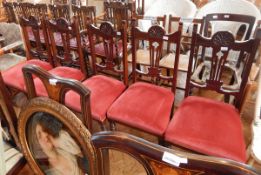 A set of five dining chairs with carved central splats, shell carved top rail, red cushions,