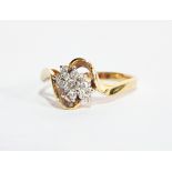 A gold crossover diamond ring, the centre set with an elongated cluster,