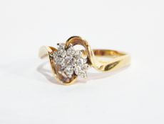 A gold crossover diamond ring, the centre set with an elongated cluster,