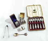 A set of six coffee/teaspoons, cased, Sheffield 1959, four various silver napkin rings,