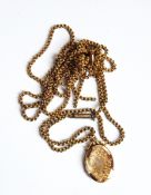 A Victorian gold back and front oval locket on a gold belcher link chain and another gold belcher