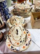 A late Victorian earthenware part dinner service to include lidded oval two-handled soup tureen,