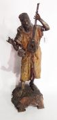 Painted spelter figure of eastern musician, on ornate base,