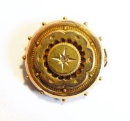 A Victorian gold target brooch, the centre set with a diamond chip,