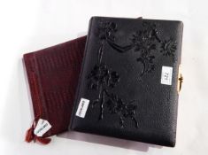 Victorian photograph album with floral decorated pages, floral embossed leather binding,