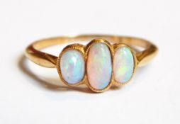 A gold three-stone opal ring marked 18ct