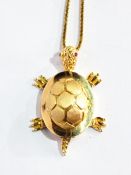 An 18ct gold turtle pendant with ruby eyes and moveable joints,