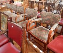 A set of four 20th century dining chairs with floral decorated cushions,