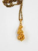 A gold-coloured nugget set as a pendant, approx. 5.