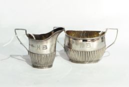 A late Victorian silver cream jug of half-reeded form,