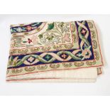 An embroidered woollen chain-stitch wall hanging, two tapestry tie-backs, a satin coverlet,