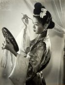 Francis Wu "Vanity" Half length portrait of woman in traditional dress applying make-up,