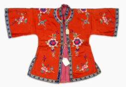 A Chinese child's embroidered red silk jacket and trousers with embroidered hat with metal