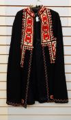 A black wool cape with Austrian style felt applique and embroidered panels