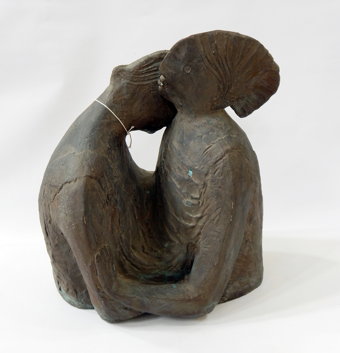 Resin sculpture of two people embracing,
