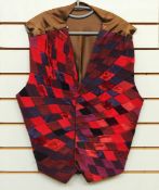 A 1980's Louise Verity patchwork waistcoat in shades of reds and blues