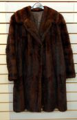 A vintage musquash coat, a vintage fur coat labelled "The National Fur Company",