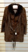 A 1970's goatskin brown leather and mink collar three-quarter length coat with leather tie belt