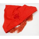 Fringed red shawl decorated with raised flowers