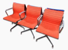 Set of six Eames open armchairs with orange upholstery,