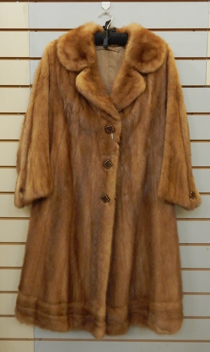 A 1960's mink coat with gilt and leather buttons, bell sleeves, a half belt to the back,