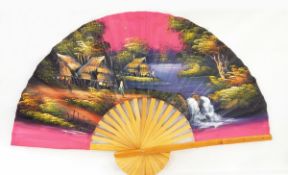 A large fabric and bamboo fan, a carved bakelite purse with lilies, possibly a collection purse,