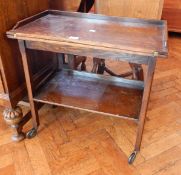 An oak folding top tea trolley with undershelf,