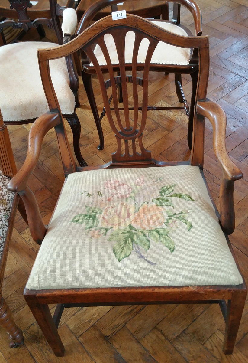 A Georgian mahogany open armchair with hump shaped crest rail and pierced splat grospoint woolwork