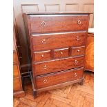 A Stag furniture chest of three short and four long drawers, raised on bracket feet,