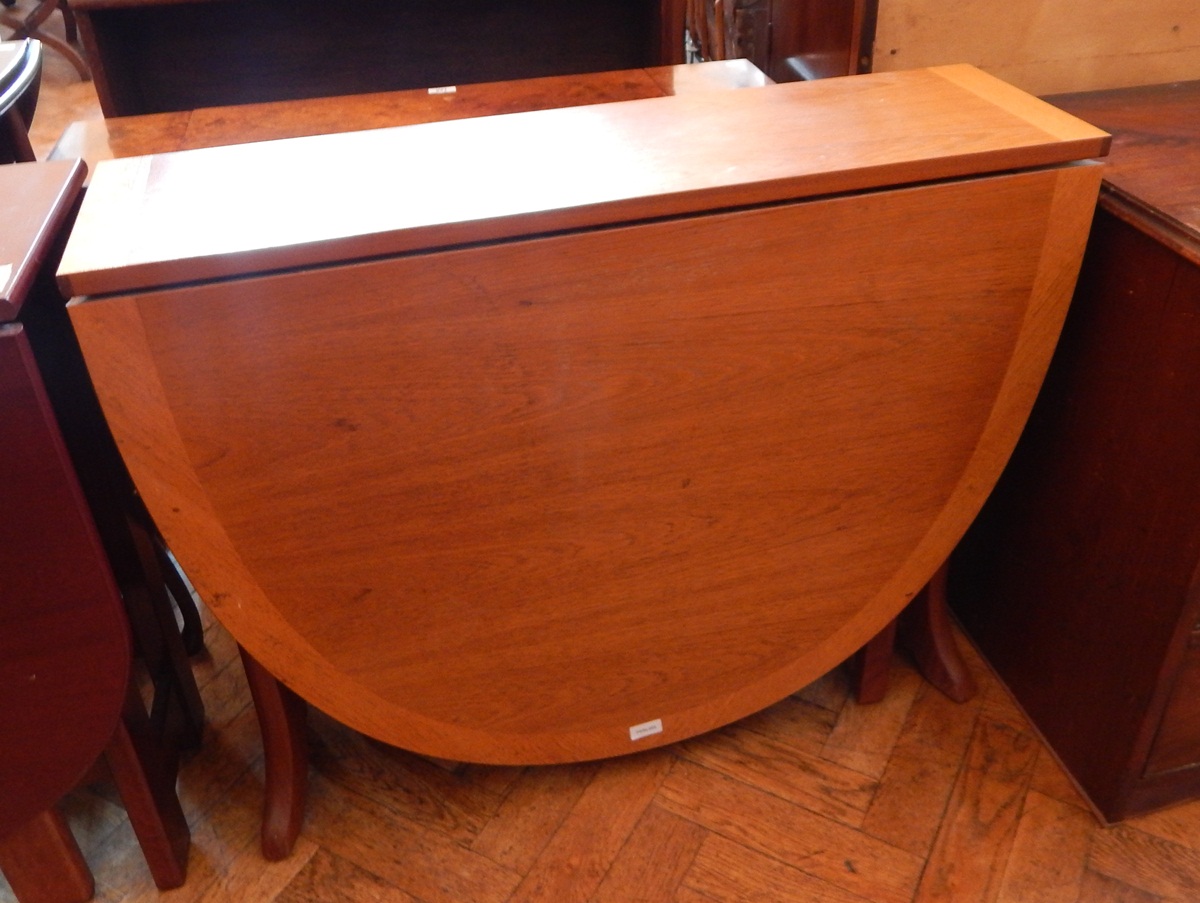 A 20th century drop-leaf table on splayed legs,