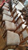 A late Victorian/Edwardian oak framed set of four dining chairs with padded back,