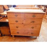 A Victorian pine chest of two short and three long graduated drawers, raised on bun feet,