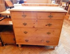 A Victorian pine chest of two short and three long graduated drawers, raised on bun feet,