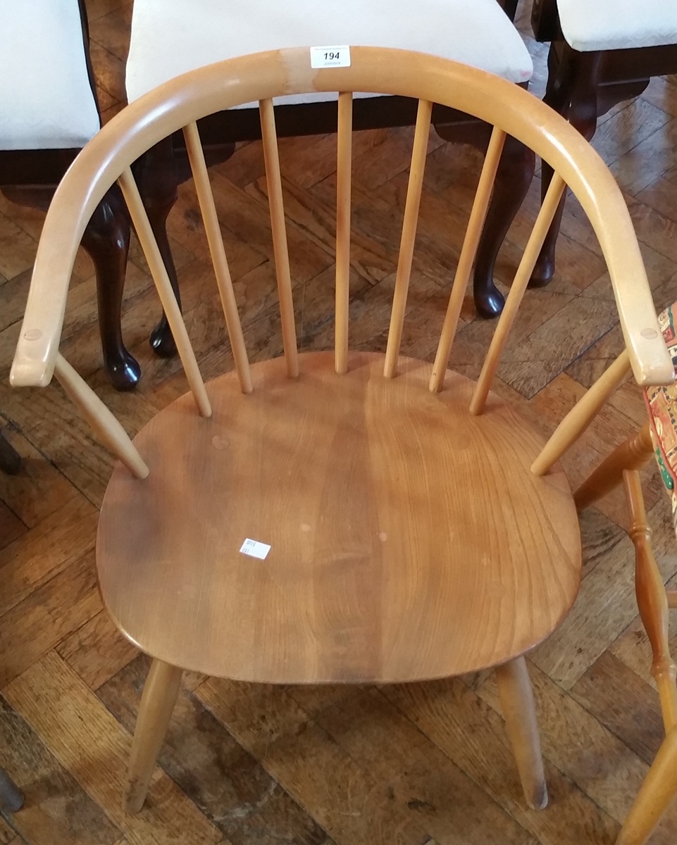 An Ercol elm seated stickback tub chair