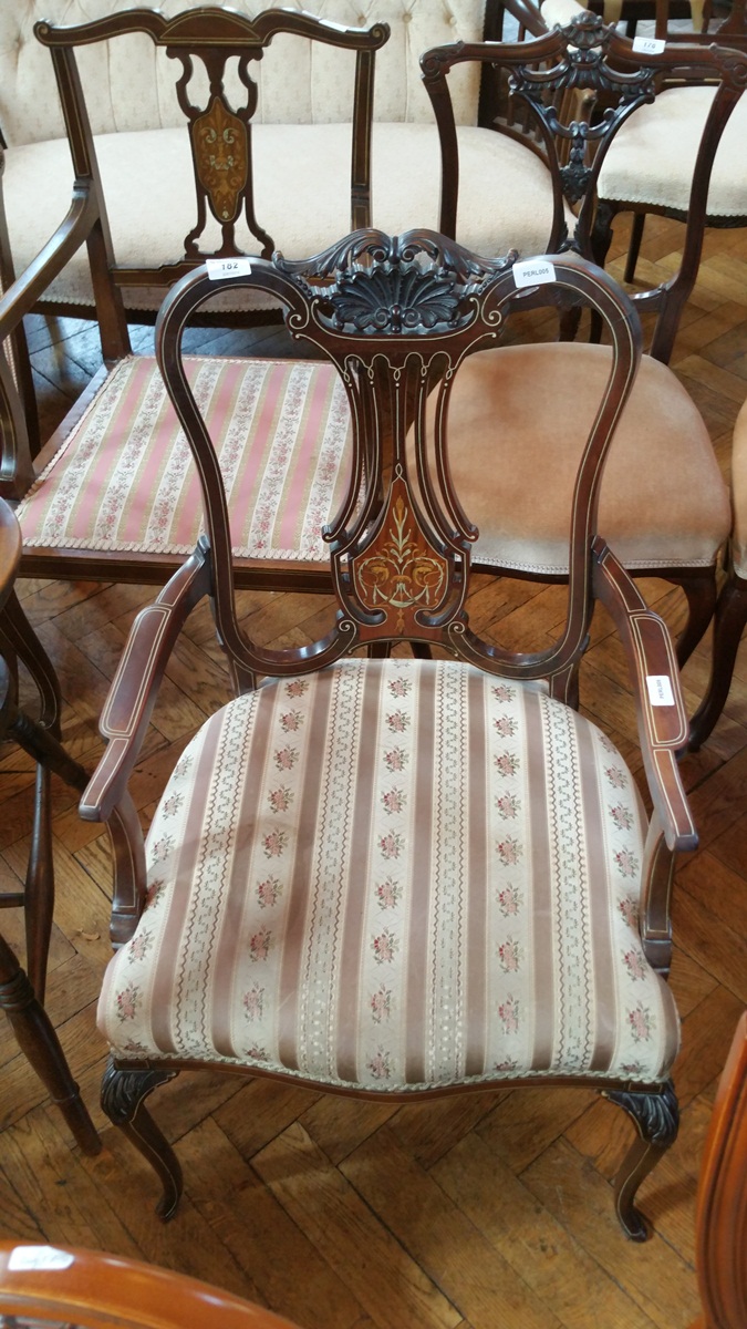 An Edwardian mahogany and inlaid open arm elbow chair having carved crest rail,