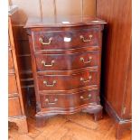 A reproduction Georgian style mahogany serpentine front chest of four long drawers,