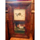A late 19th century American wall clock with striking movement, a pine four-shelf plate rack,